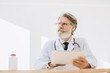© dsheremeta - Portrait of senior doctor using application on tablet computer