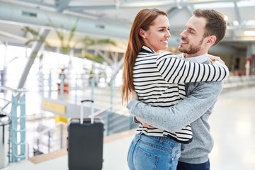 Wall Mural - Happy couple hugs each other after the trip