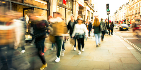 Wall Mural - Motion blurred people walking on busy street
