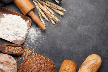 Various bread with wheat, flour and cooking utensils