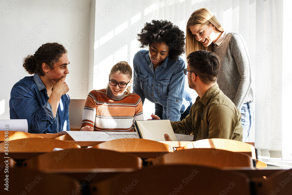 Absord Engage In the university classroom, a group of attentive students gathers ...