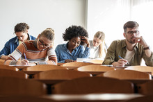 Group Of University Students Taking A Test In A Classroom.Educational Concept.	
