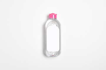 Wall Mural - Micellar water bottle with blank label isolated on white background.Makeup remover, natural moisturizing lotion Mock-up. Transparent liquid container.High-resolution photo.