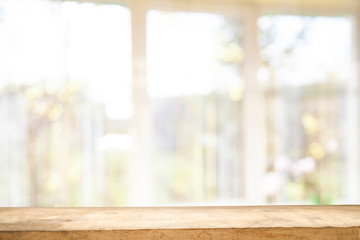 Top of wooden table on window glass blur. Of green from the garden of the vegetable garden on a morning background. To display product montage.