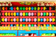 Balloons And Prizes At A Dart Throwing Game Booth At A Carnival, Fair, Or Amusement Park