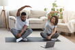 © Prostock-studio - Young Happy African American Couple Training Together In Front Of Laptop