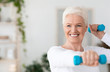 © Prostock-studio - Portrait Of Happy Elderly Woman Exercising With Dumbbells At Home