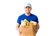© alenaphoto - Happy Delivery man in blue cap blank tshirt uniform glove hold donations bag on isolated on white background. Service quarantine pandemic coronavirus virus 2019-ncov concept Pandemic. Donation food
