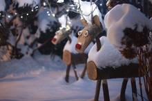 Wooden Reindeer Sculptures On Snow Covered Field
