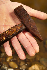 Man found rusty iron metal hammer in river water by magnet