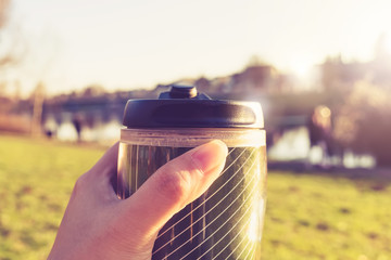 Hot Coffee tea by river in reuse recycle glass sit alone enjoy relax refresh sun summer warm morning weather holiday social distancing due to coronavirus  pandemic outbreak quarantine city lockdown 