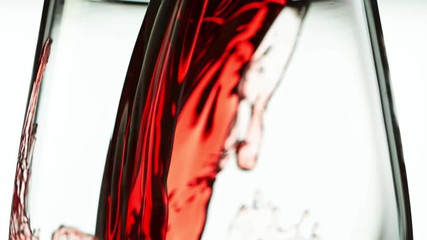 Wall Mural - Super Slow Motion Detail Shot of Pouring Red Wine from Bottle on white Background at 1000fps.