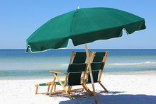 Two Chairs And Green Umbrella On White Sand Beach
