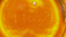 Corn Syrup Thickener And Sweetener Ingredient. Macro Close Up Of Floating Orange Syrup Bubbles. Product And Commercial Uses In Food Preparation