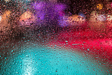 Multi Colored Light Seen Through Wet Glass Window During Monsoon
