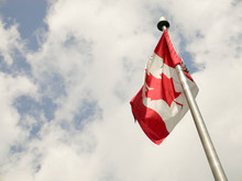 Low Angle View Of Canadian Flag Against Sky