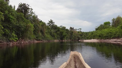 Wall Mural - Sailing on Indigenous canoe in Corocoro river. Amazon state Venezuela