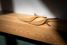 Wooden Ornamental Leaves Laid Out On An American Oak Mantle Piece Above A Fireplace