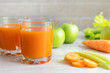 Two glasses with carrot juice, celery and green apple on the table. Diet, healthy eating, food and weigh loss concept.