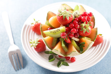 Sticker - fruit salad in melon bowl with berry fruit, kiwi and banana