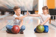 © Pixel-Shot - Little children playing bowling in club