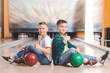 © Pixel-Shot - Little boys playing bowling in club
