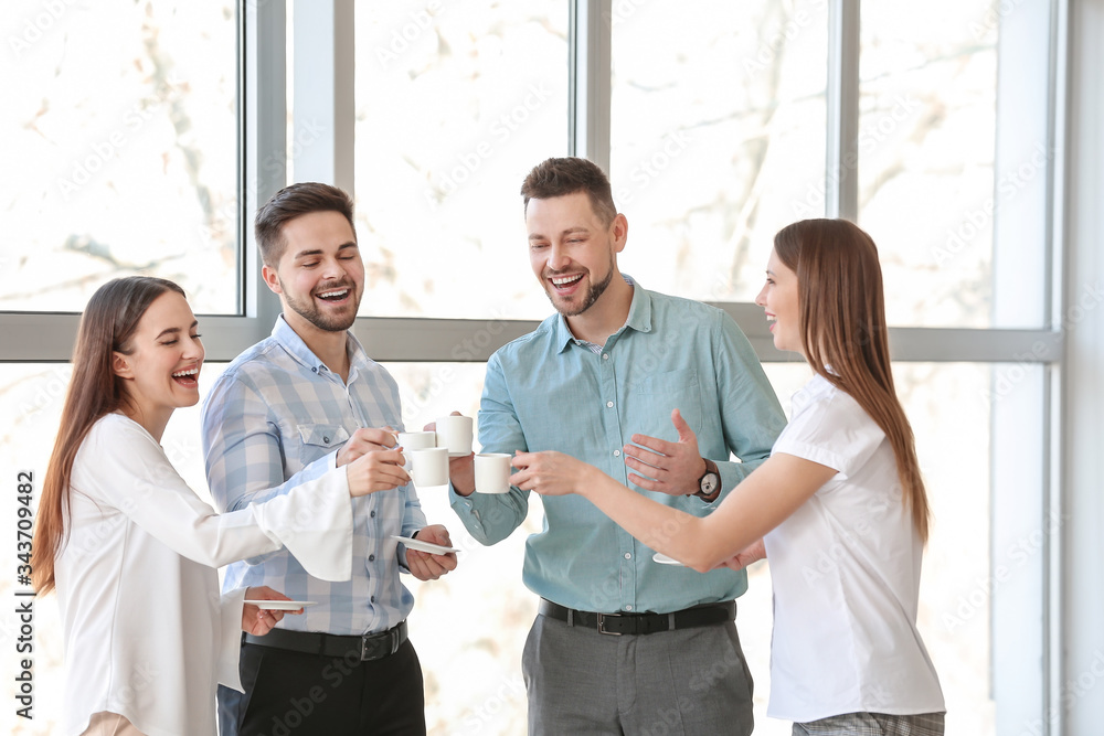 Colleagues drinking coffee in office