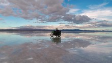 Motorcycle Travel Adventure With Rider Piloting Drone, Modular Helmet, Luggage, Green Bike In Uyuni Bolivia Salt Flat South America On A Kawasaki KLR Dual Sport Enduro Motorbike,motorcycle Diaries