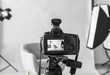 © Pixel-Shot - Professional camera on tripod in modern photo studio