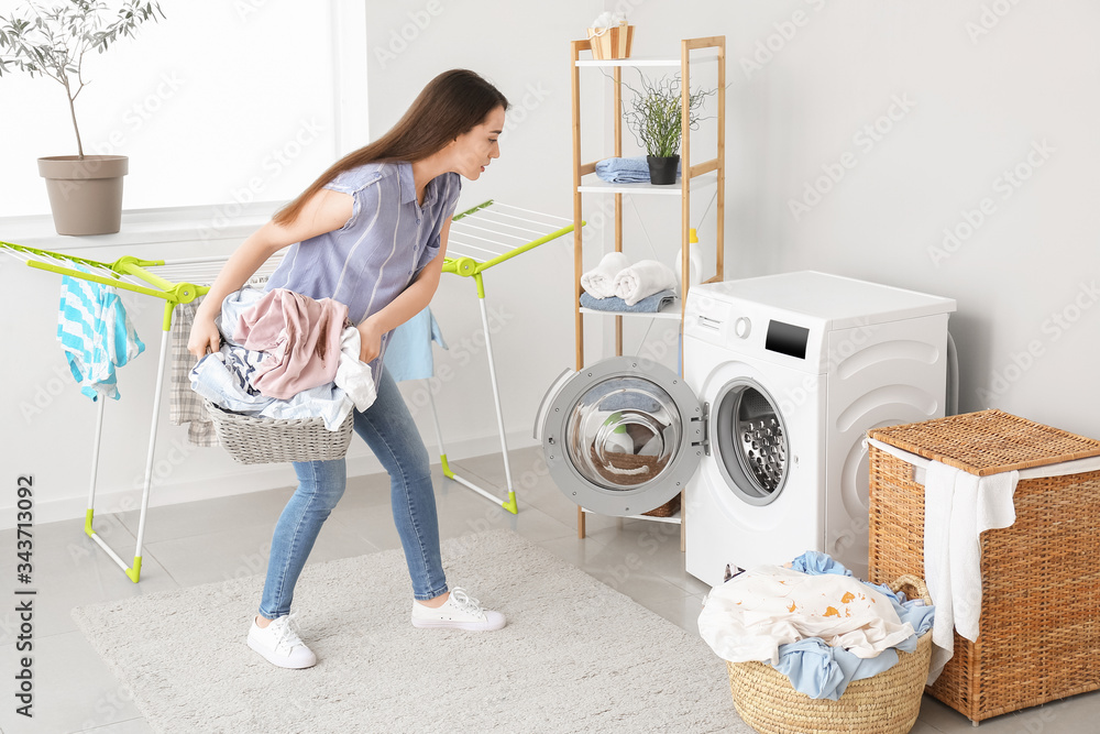Young woman doing laundry at home