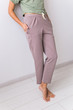 © satura_ - Close-up of female dressed in beautiful colorful pajama posing as a model in her living room. Comfortable sleepwear, home relaxation and female fashion concept.