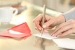 © PheelingsMedia - Woman hand writing greeting card at home