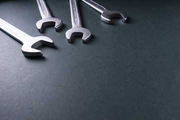 Metal wrenches on a dark background