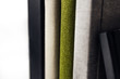 close up of four standing photobooks with beautiful textile covers, side cover view, luxury linen material