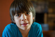 © Emanuele Capoferri - portrait of child ten years old he look on the camera and smile - headshoot of kid at home