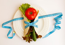 Tomato, Cucumber, Salade Lives On Plate, Blue Measuring Tape Wrapped Around Pita Bread On A White Background, Weight Loss And Proper Fit Lifestyle, Diet Concept