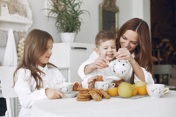 Cute little child with mother. Family at home in a kitchen. Mother with child have a meal.