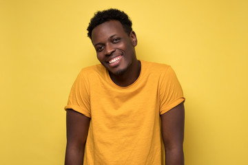 Canvas Print - african american man in yellow clothes, smiling broadly