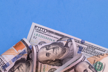 Money notes on a blue background. Place for text, copy space.