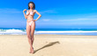 © vladnikon - Woman swimsuit on beach.