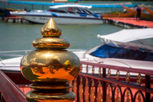 Reflection In A Golden Figure In Thailand