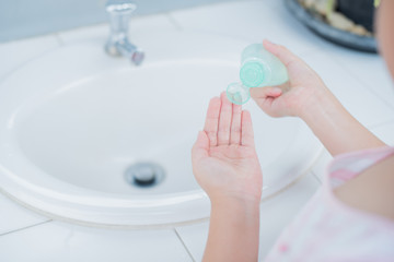 coronavirus pandemic prevention little asian girl is wash hands with soap warm water and rubbing nails and fingers washing frequently or using hand sanitizer gel. hygiene concept hand detail..