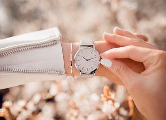 Beautiful elegant white watch on woman hand