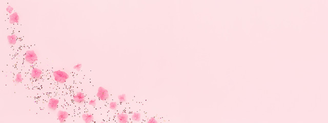 Wall Mural - banner with flowers and gold glitter confetti splash on pink background. spring holidays, birthday, 