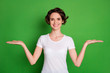 Photo of attractive lady wavy hairdo hold two open arms empty space demonstrate novelty advising pick one best sale manager wear casual white t-shirt isolated green color background