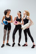 © LIGHTFIELD STUDIOS - cheerful and multicultural women holding fitness mats on white
