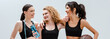 © LIGHTFIELD STUDIOS - panoramic shot of happy and multicultural girls with sport equipment isolated on white