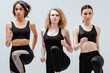 © LIGHTFIELD STUDIOS - beautiful and multicultural women in sportswear exercising isolated on white