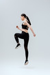 © LIGHTFIELD STUDIOS - sportive woman in black sportswear exercising on white
