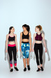 © LIGHTFIELD STUDIOS - multicultural and happy women in sportswear walking on white
